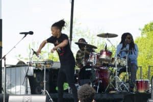 Child playing drums on stage at Anacostia River Festival